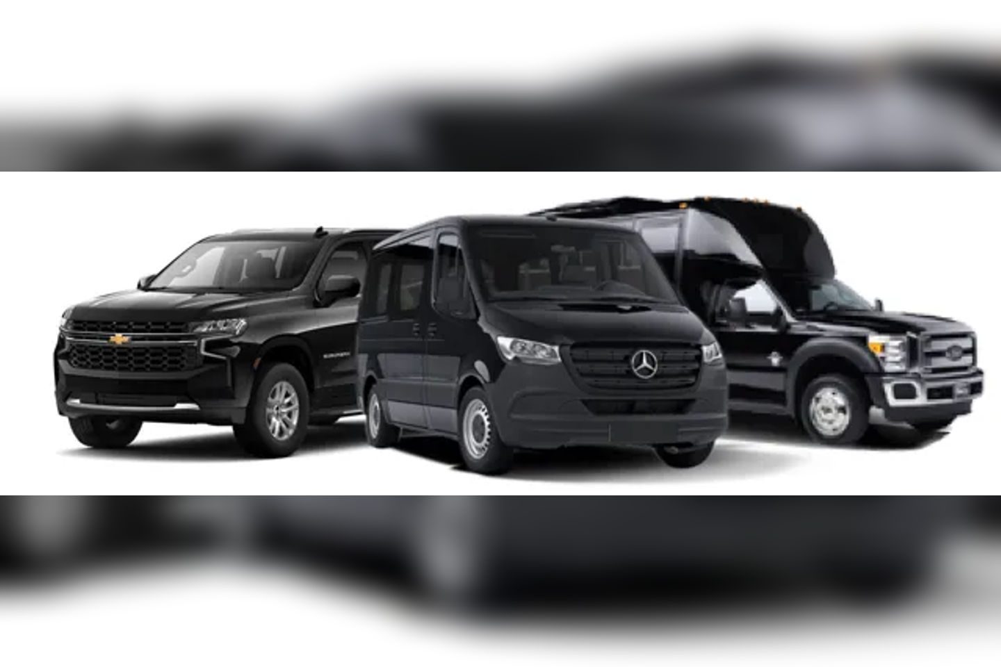 Three black Mercedes-Benz vans parked side by side.