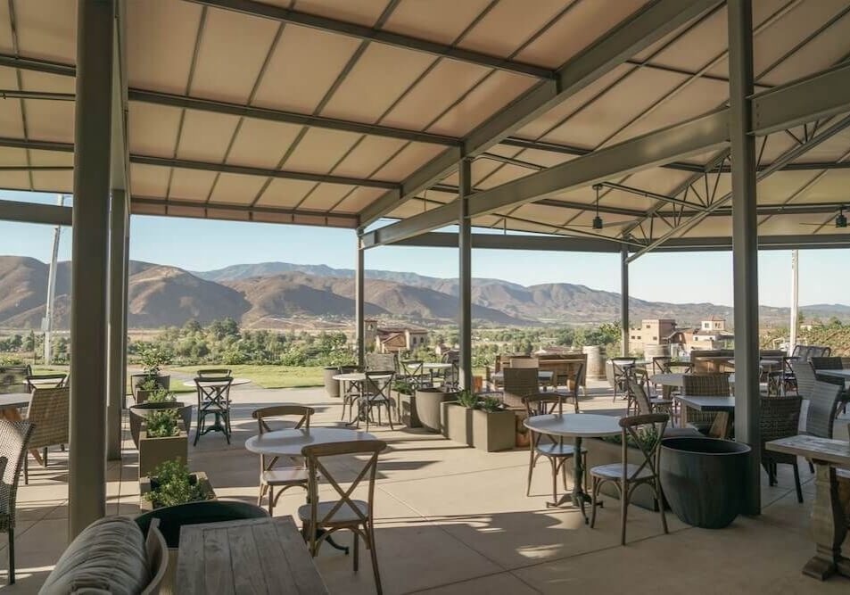 Outdoor dining area with mountain views under a covered patio.