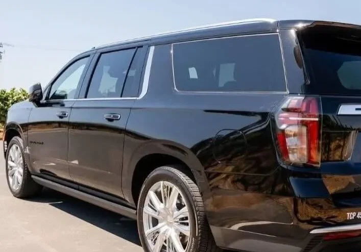 Black SUV parked outdoors on a sunny day.